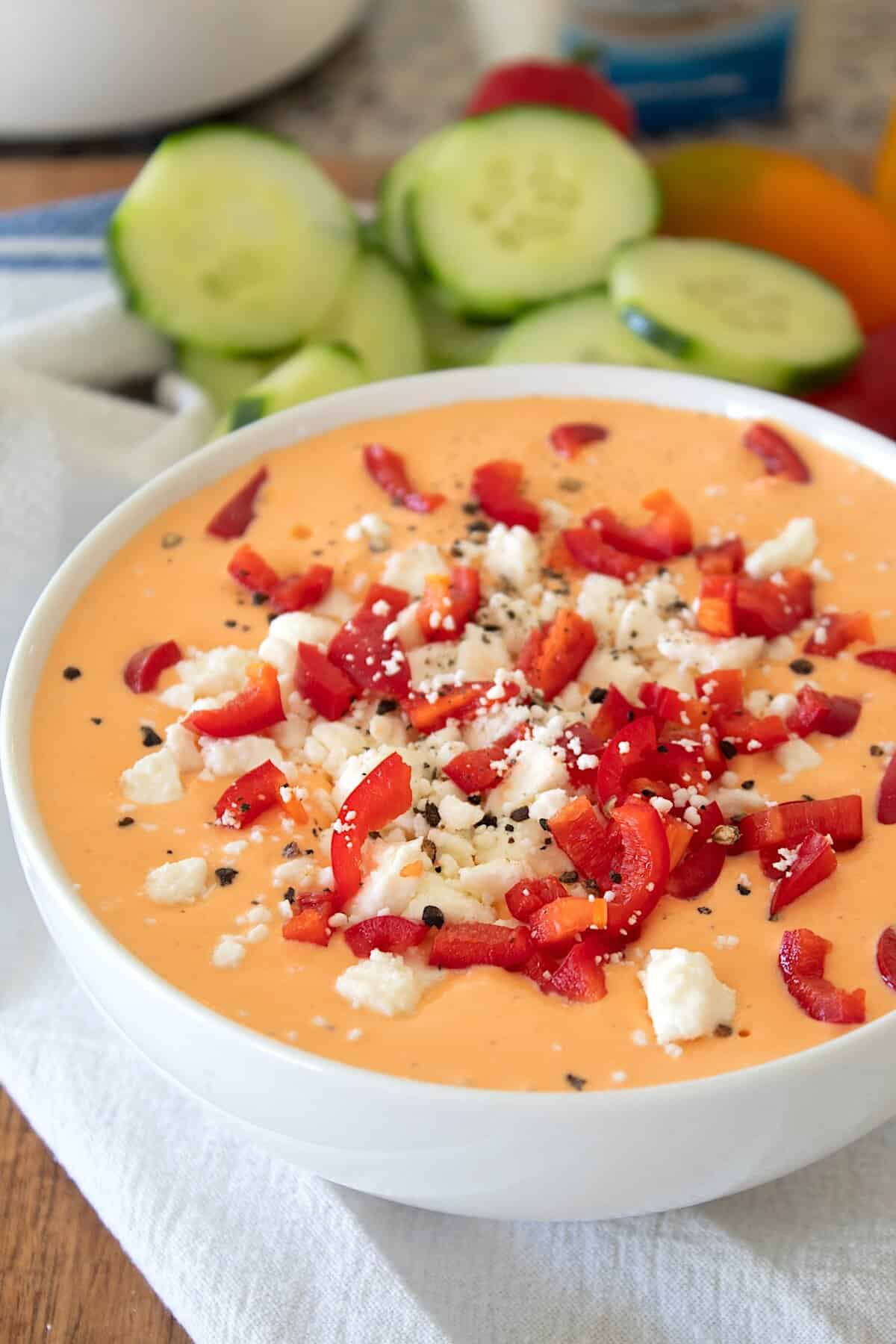 roasted red pepper dip in a bowl with feta and red peppers on top