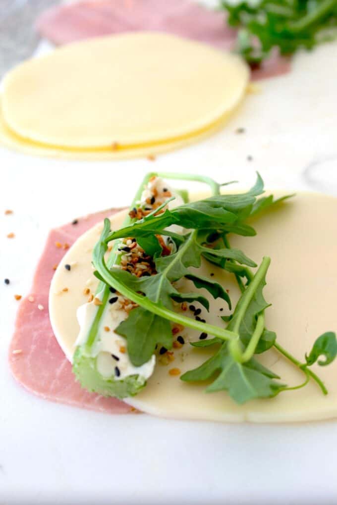 arugula with ham and cheese on celery