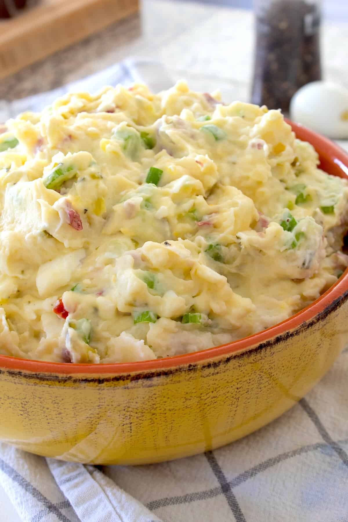 mashed potato salad in a yellow ceramic bowl