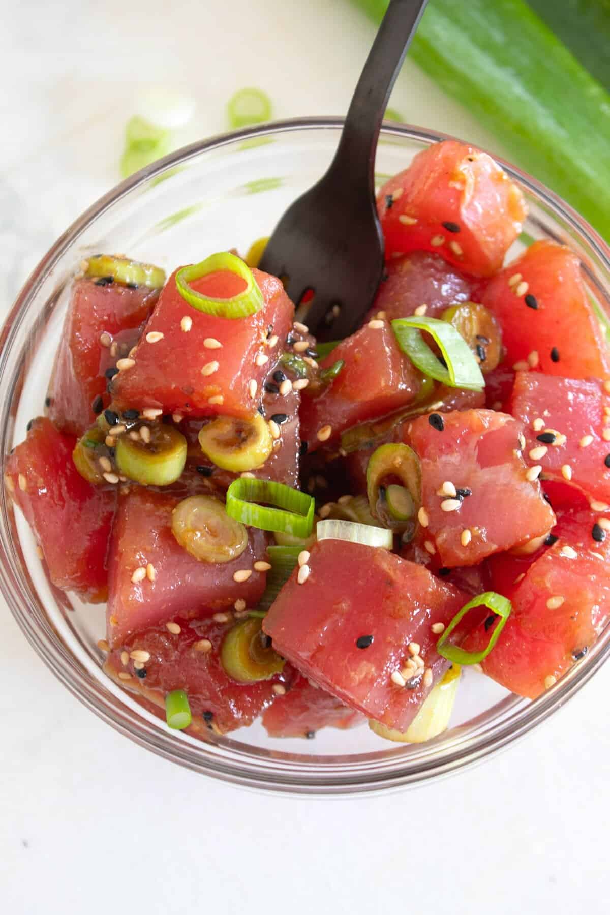 overhead view of ahi poke in a clear bowl