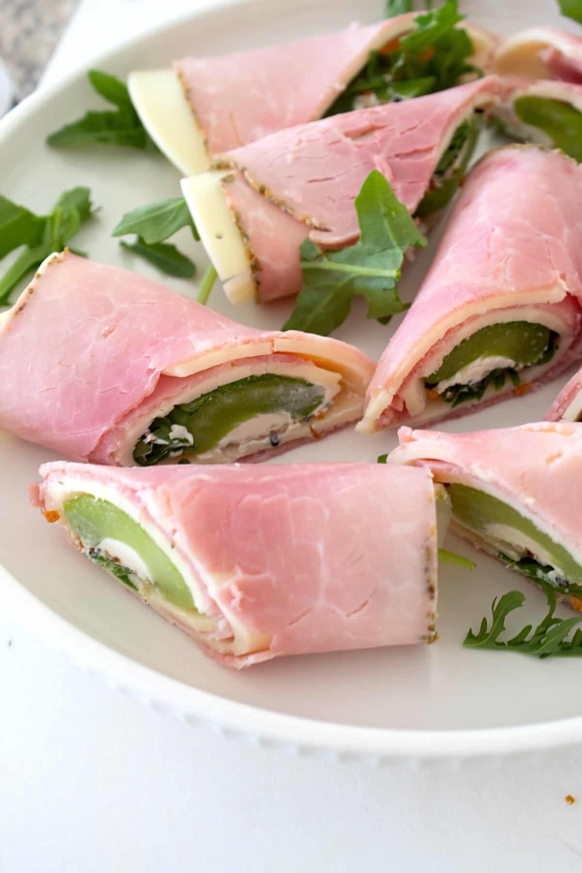 close up of celery rolls on a white plate