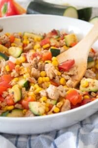 side view of chicken and zucchini skillet with spatula