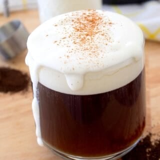 cold foam topped coffee in a clear glass