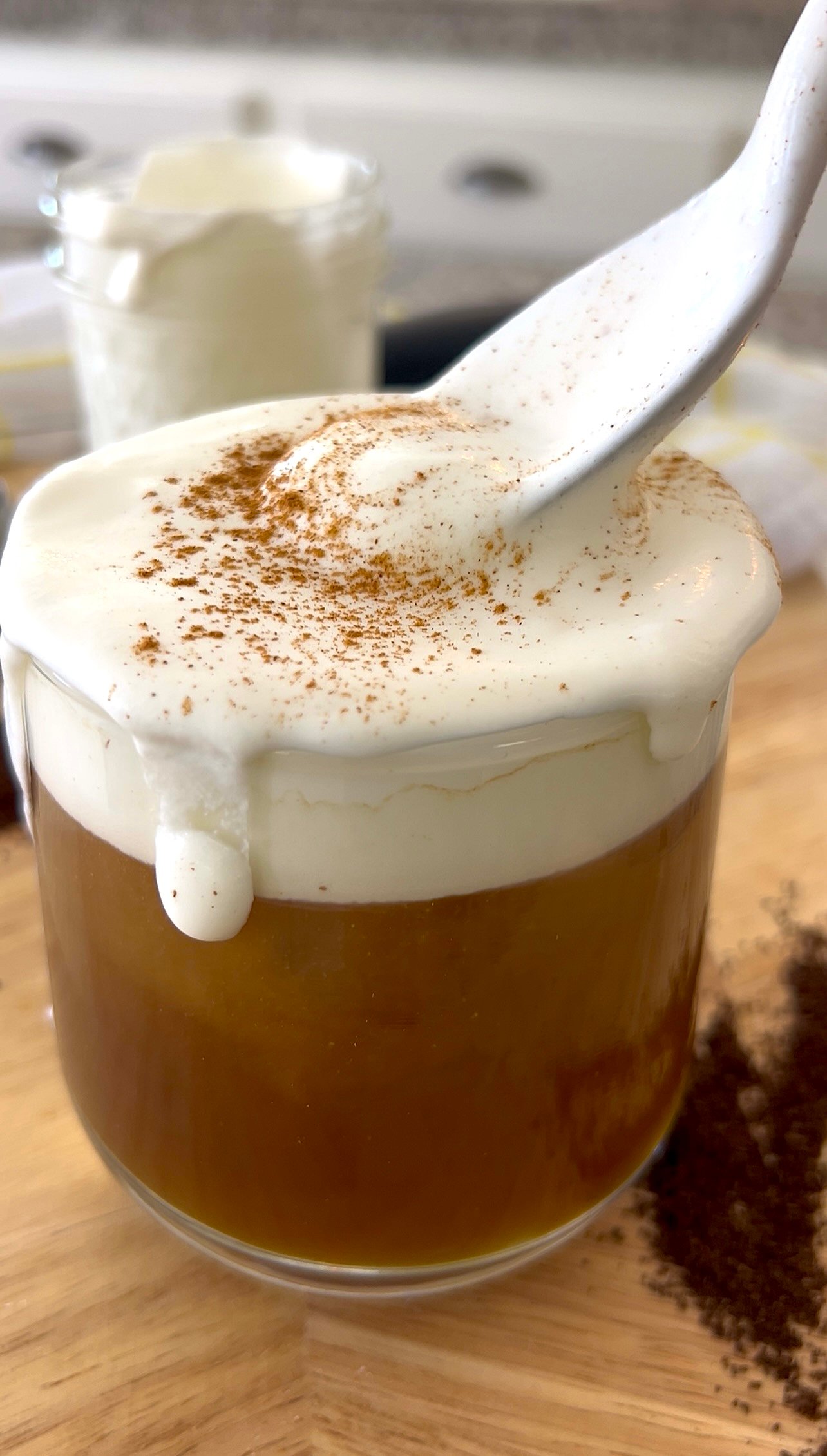 stirring cold foam topped coffee