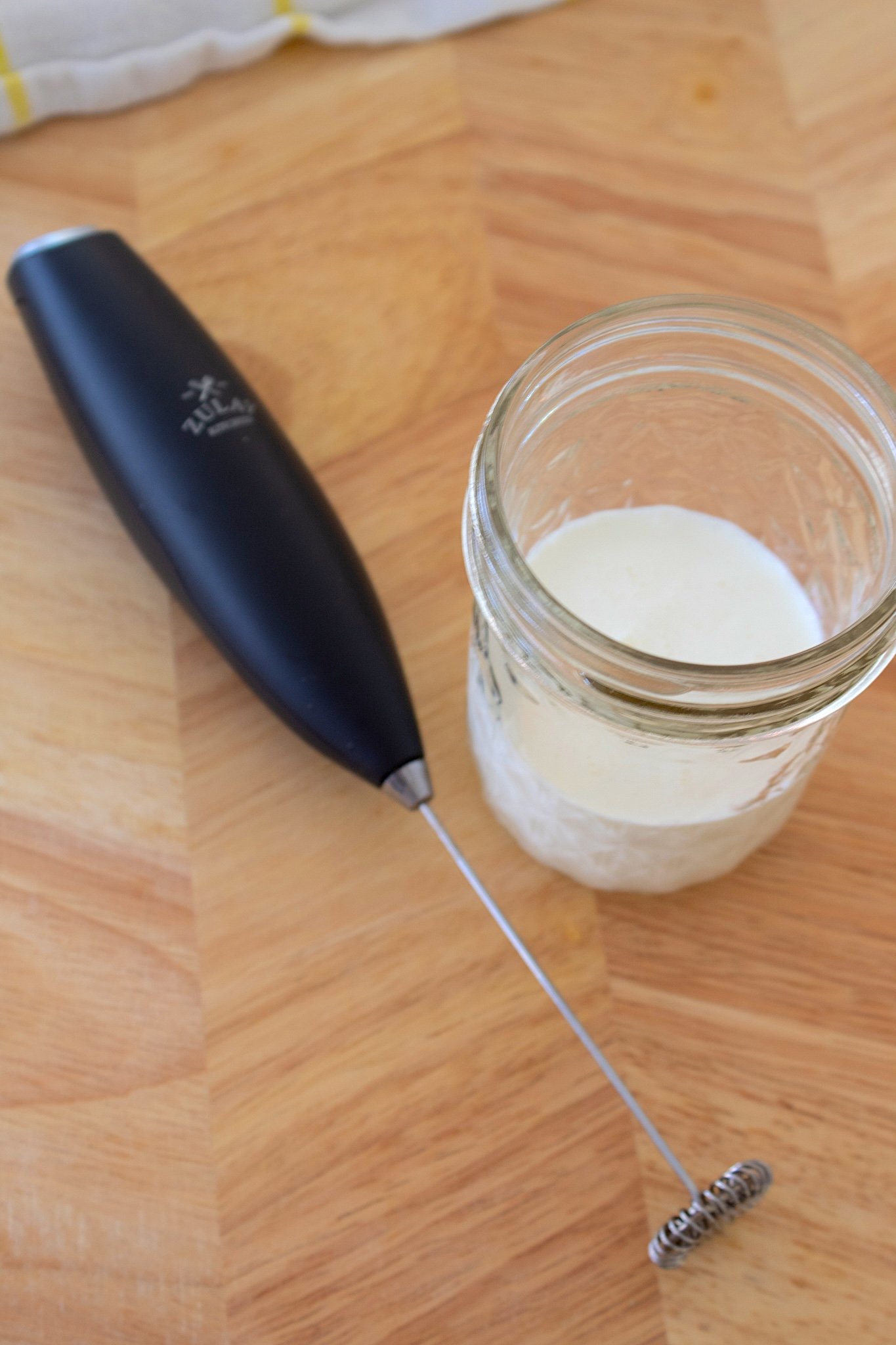 coffee frother and cream in mason jar