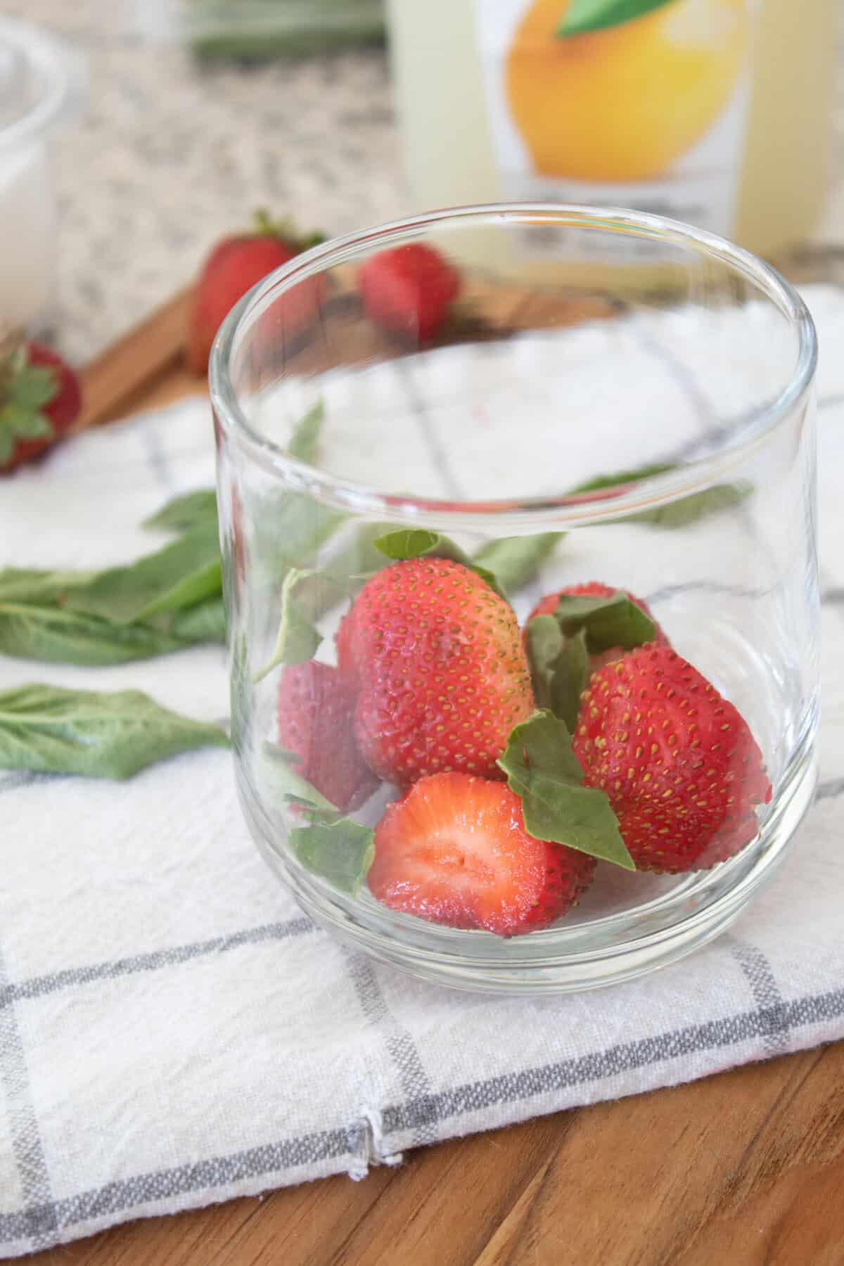 strawberries and basil in a glass