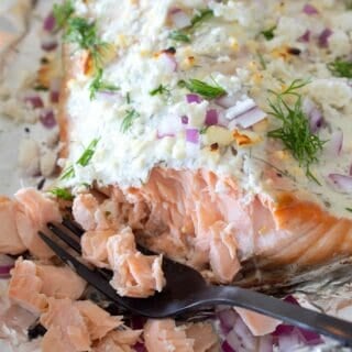 overhead view of greek yogurt baked salmon on a foil lined pan