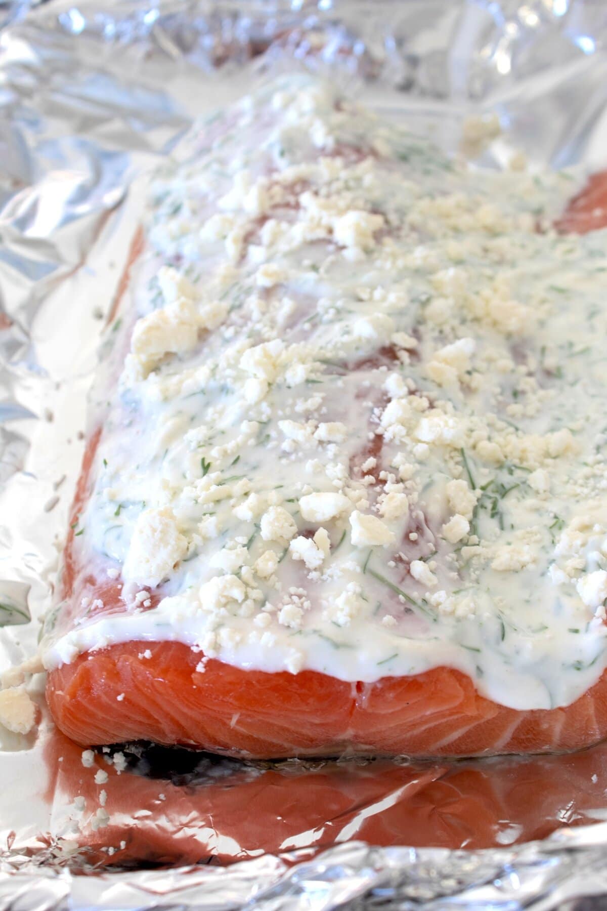 Greek yogurt slathered salmon on a foil lined sheet pan