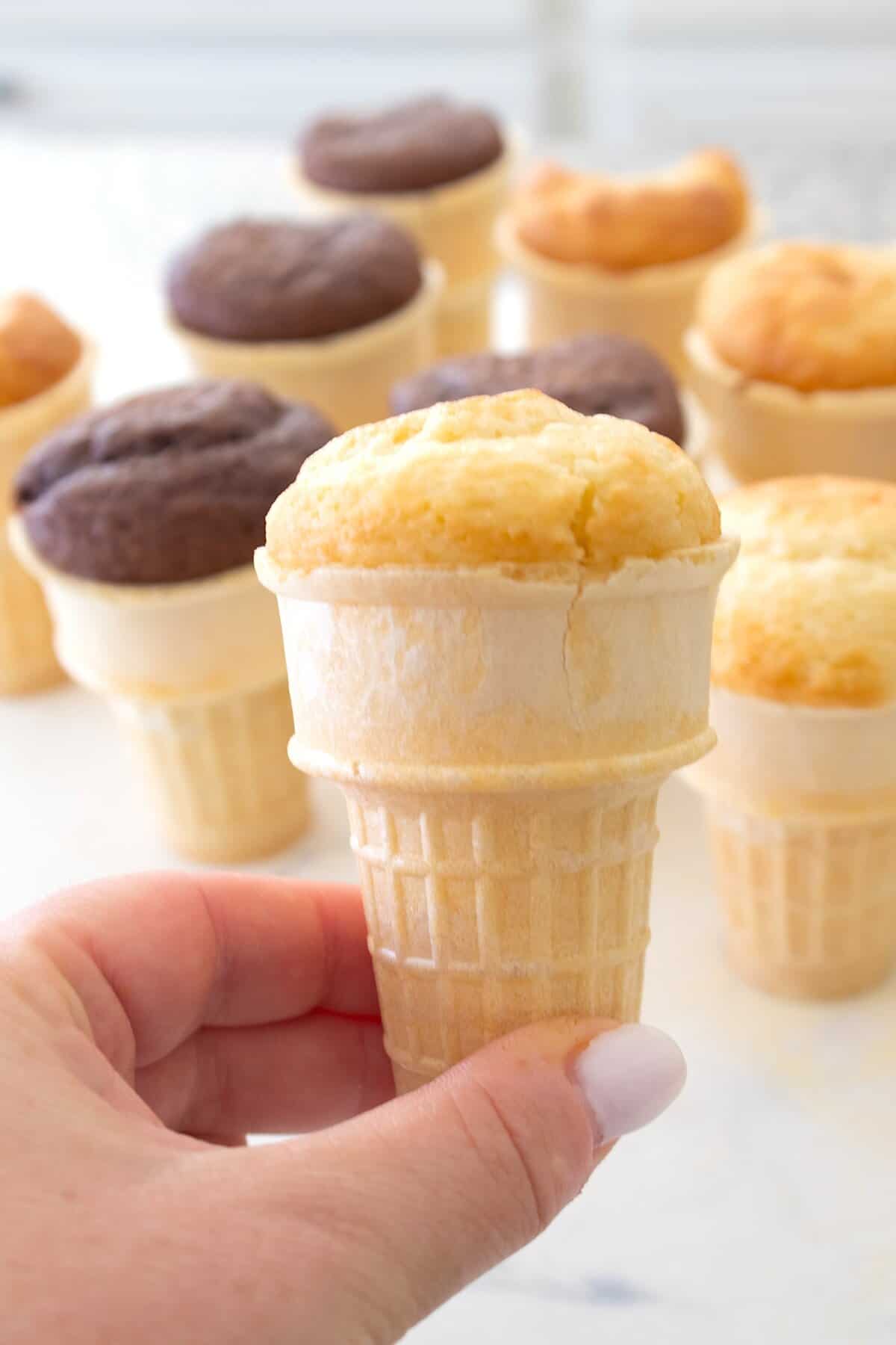holding a cake filled ice cream cone