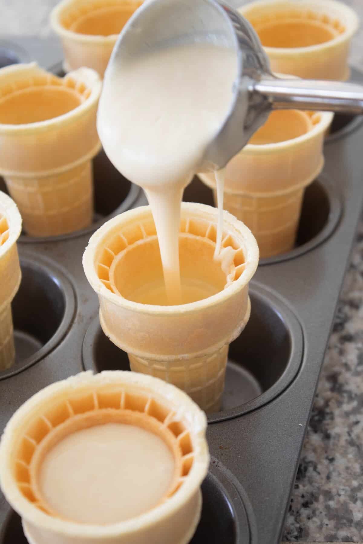 adding cake batter to flat ice cream cones