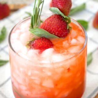 strawberry basil lemonade in a glass with garnish