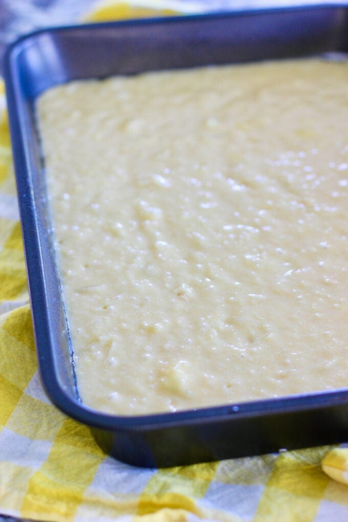 pineapple cake batter in a 9 x 13 pan
