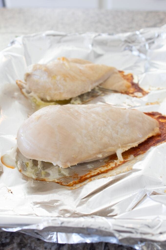 cooked chicken breast on a sheet pan