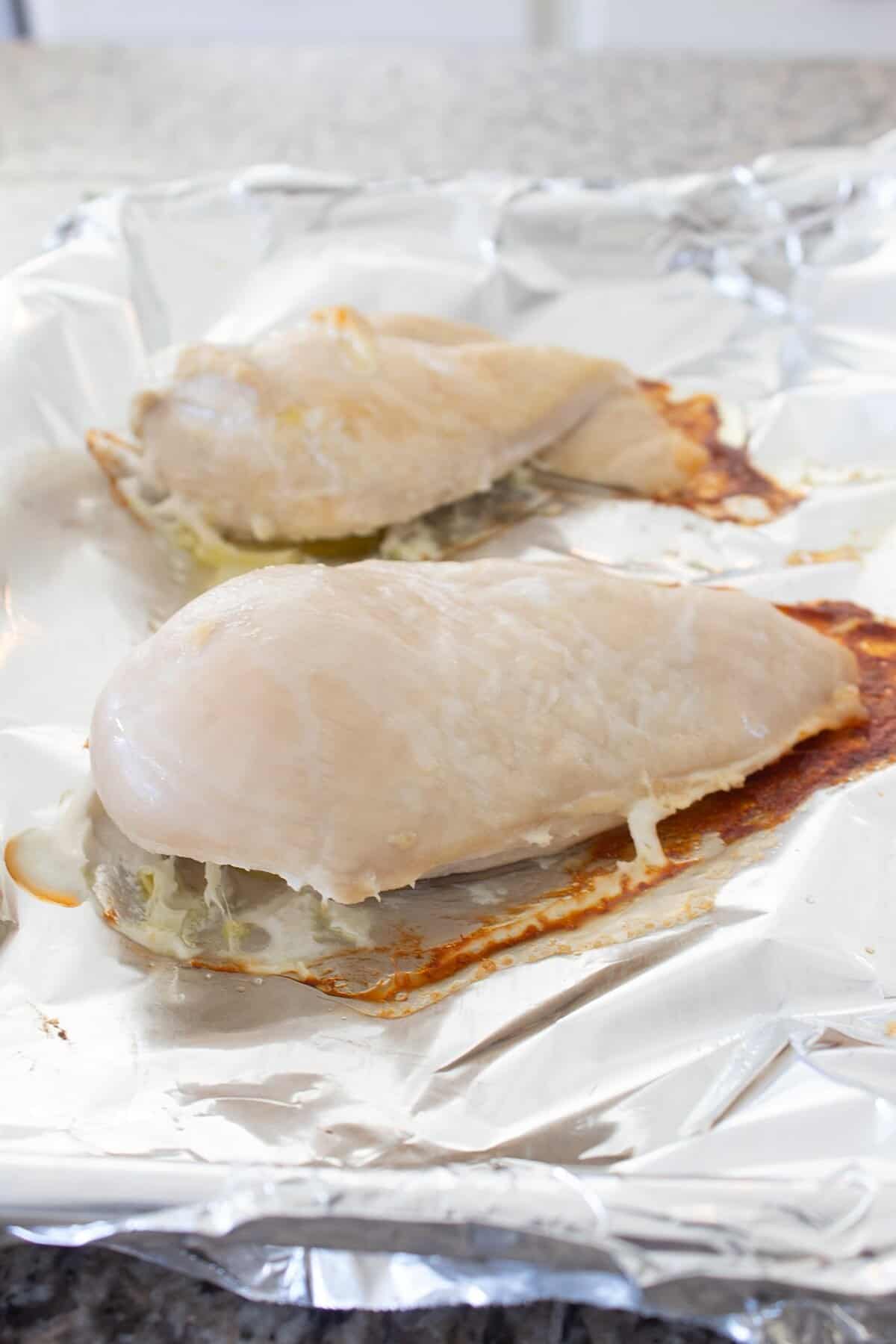 cooked chicken breast on a sheet pan