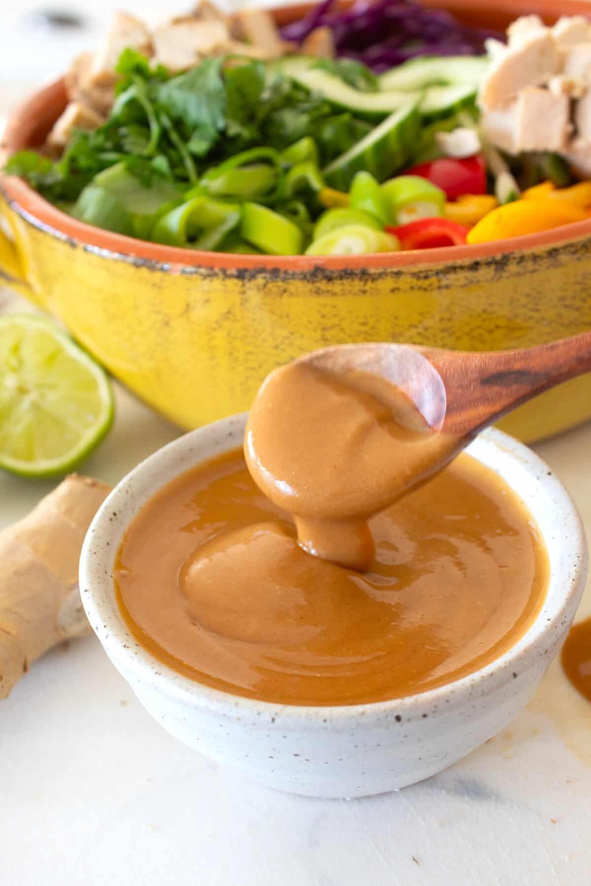 spooning thai peanut sauce in a small dish