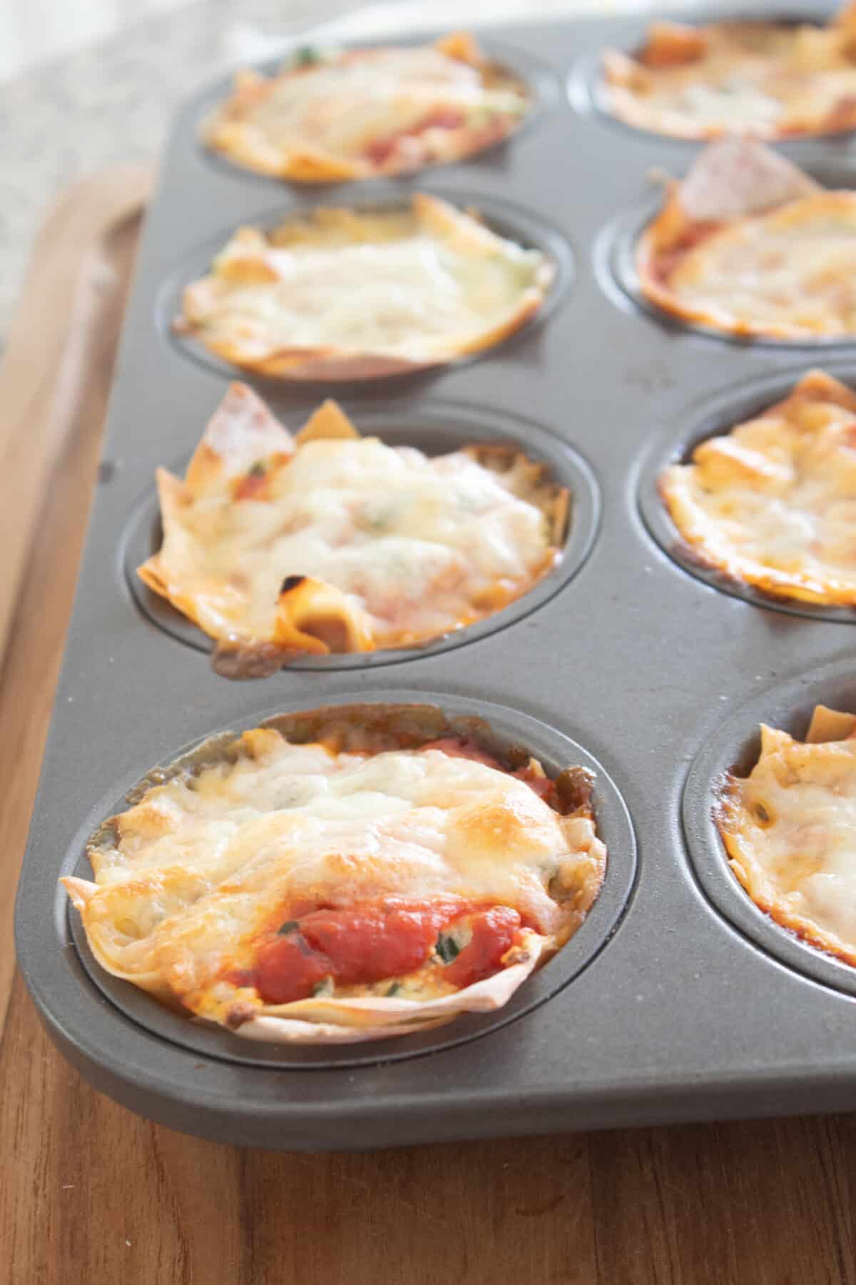 cooked wonton lasagna cup in a muffin tin