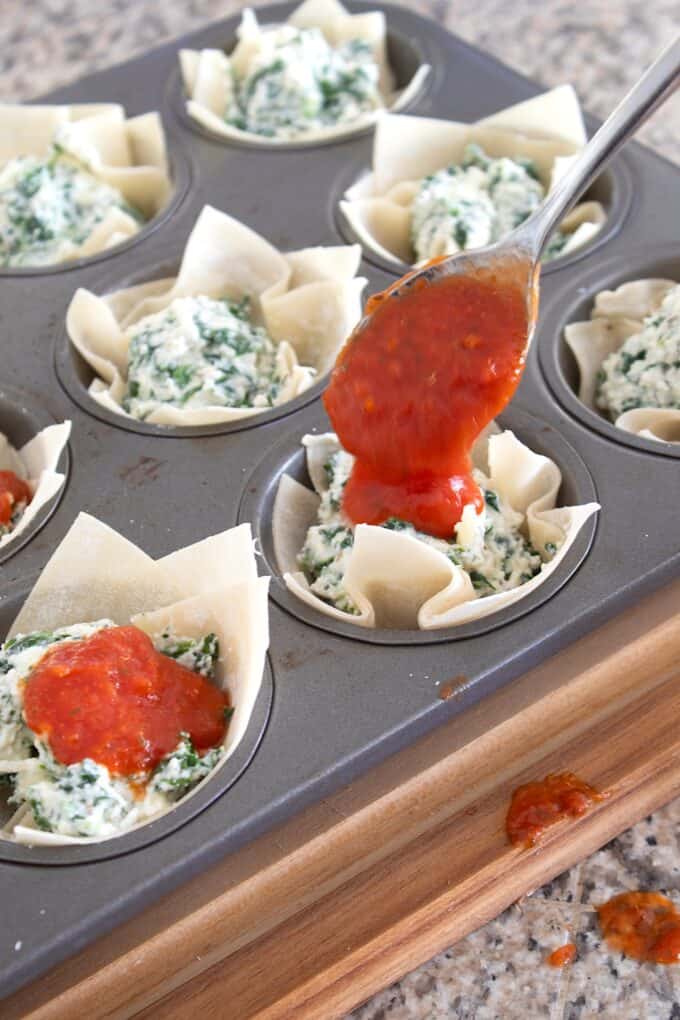adding marinara to wonton cup