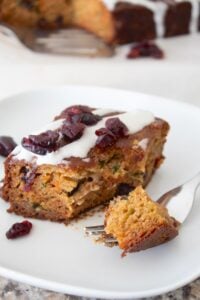a slice of snack cake on a white plate with a fork