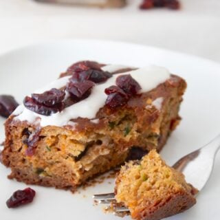 a slice of snack cake on a white plate with a fork