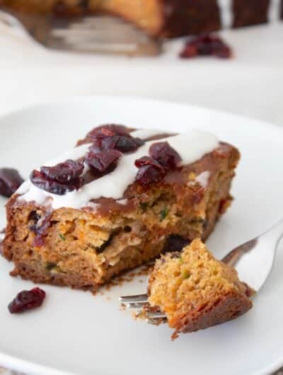 a slice of snack cake on a white plate with a fork