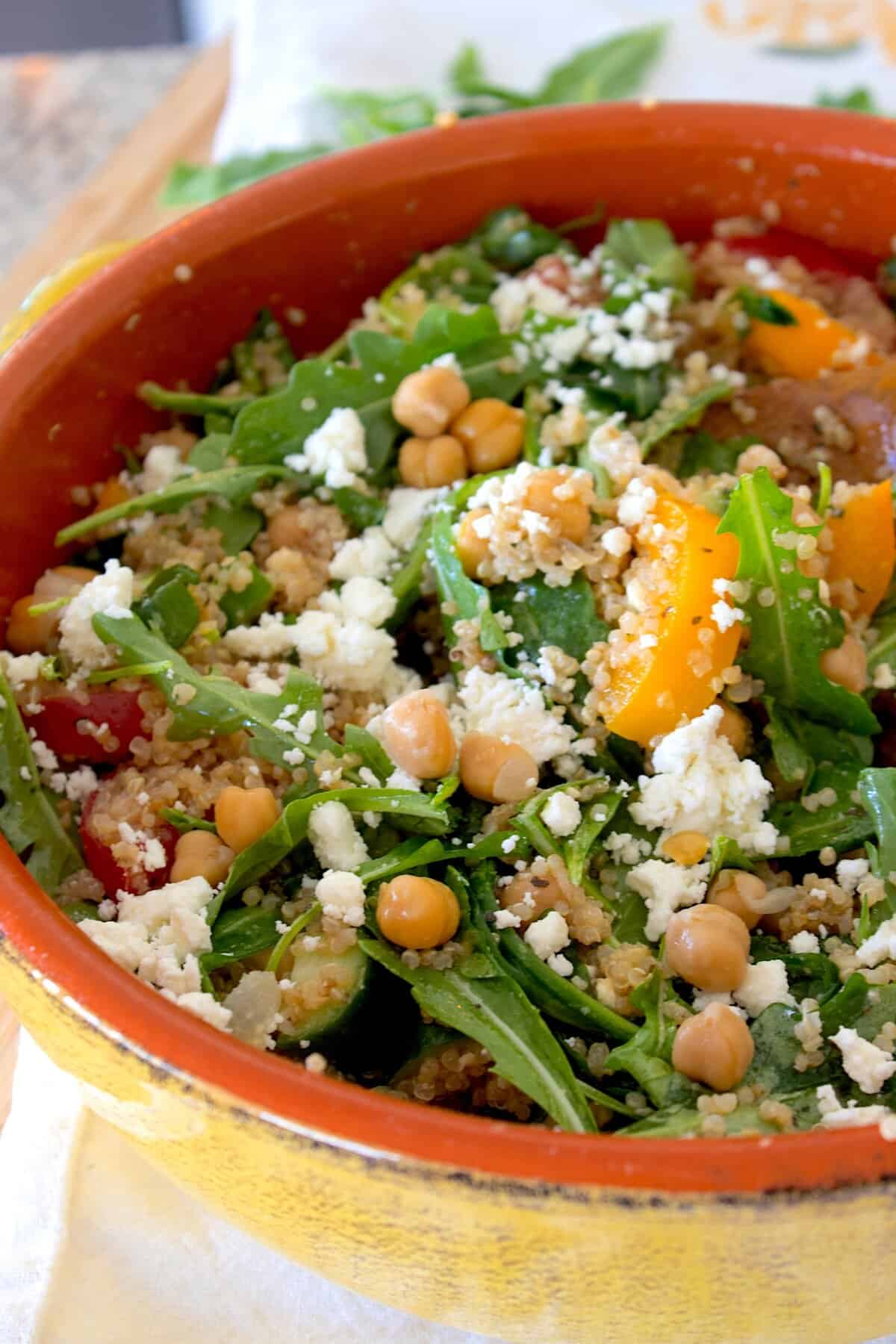 side view of quinoa salad in a yellow bowl