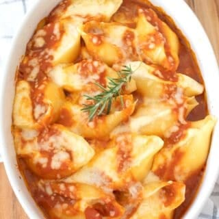 stuffed shells in a white casserole dish