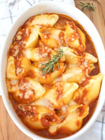stuffed shells in a white casserole dish