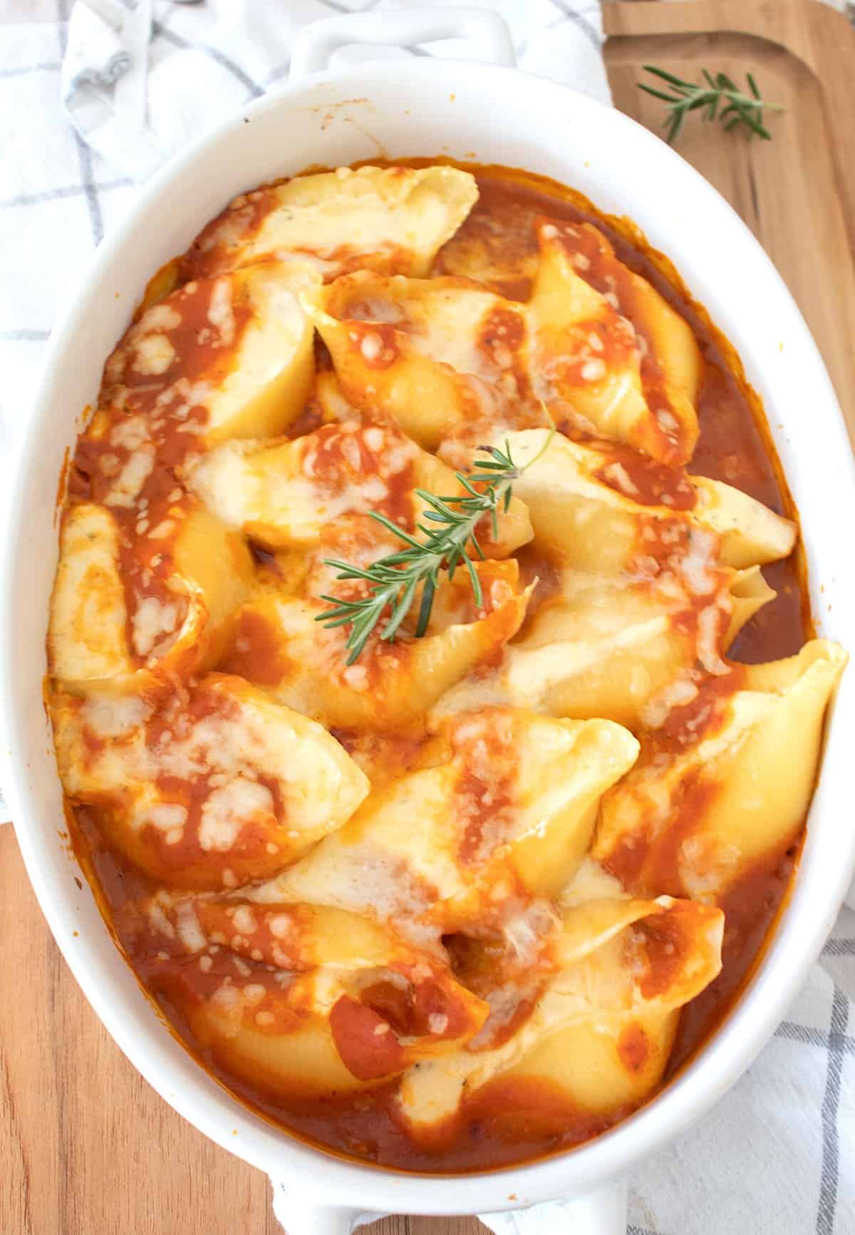 stuffed shells in a white casserole dish
