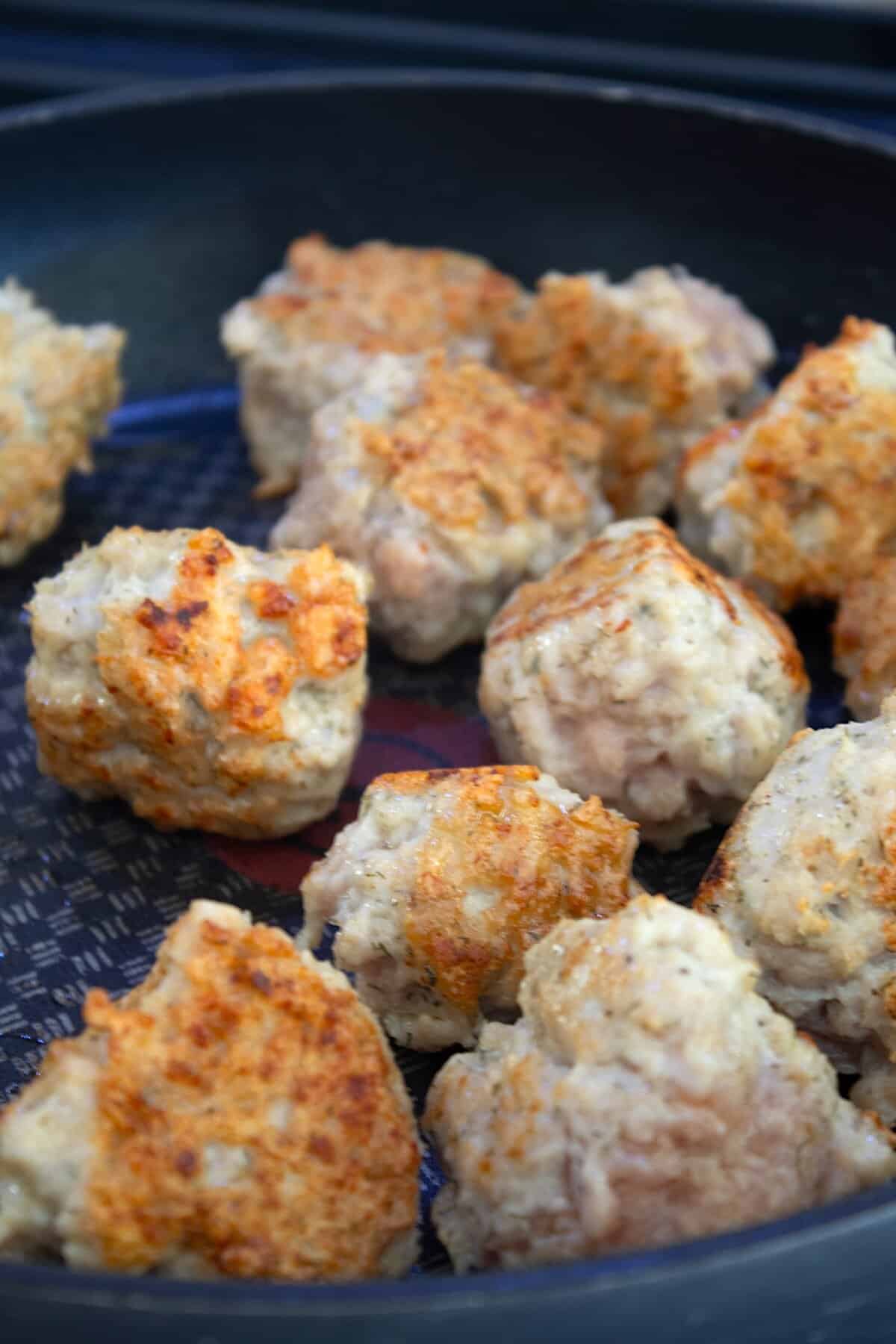 browning meatballs in a pan