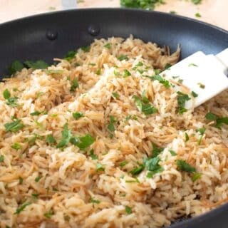 homemade rice a roni in a pan with fresh parsley