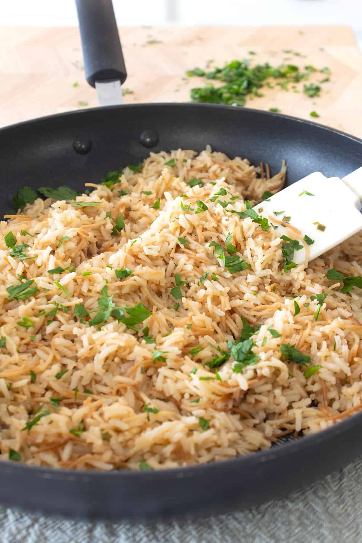 homemade rice a roni in a pan with fresh parsley