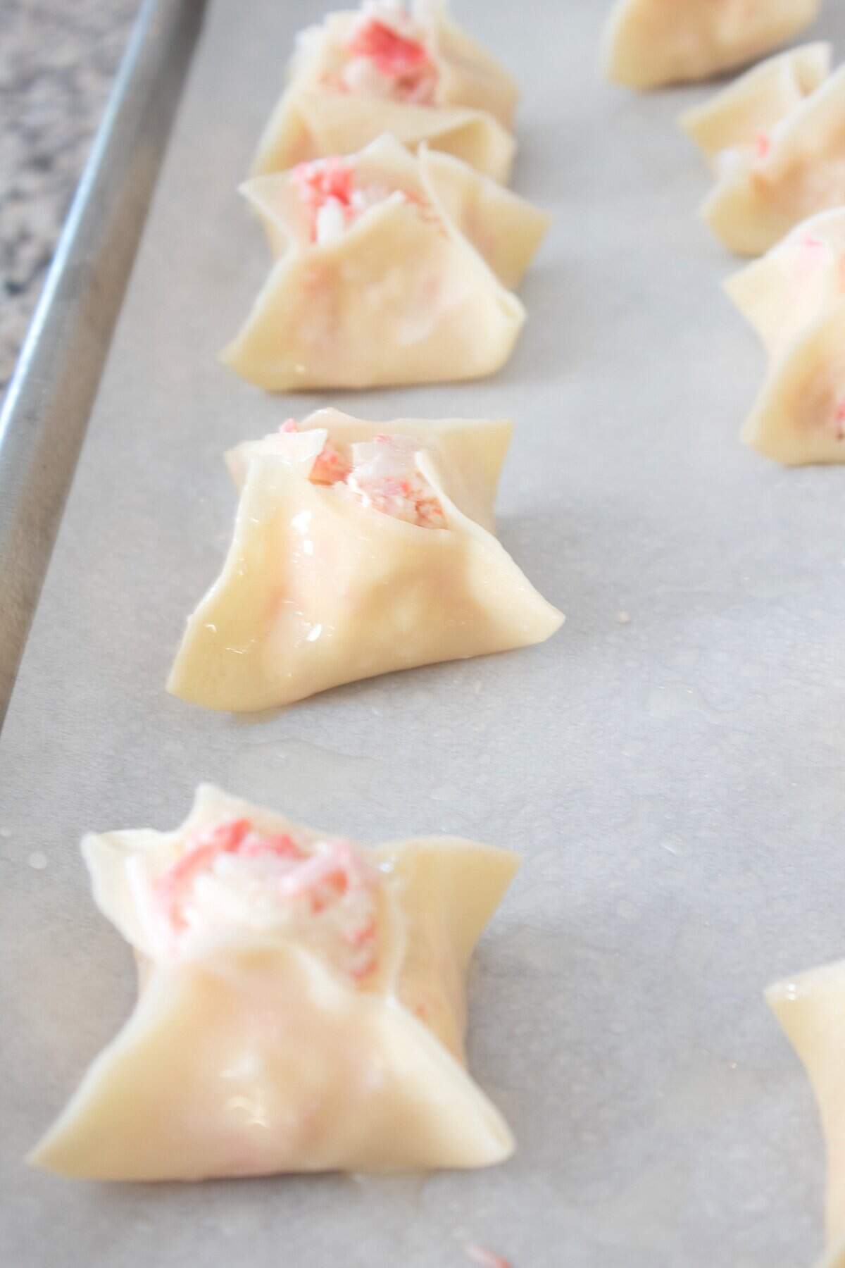 baked wontons on a sheet pan