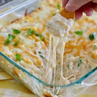 Hot corn dip out of the oven with frito scoop