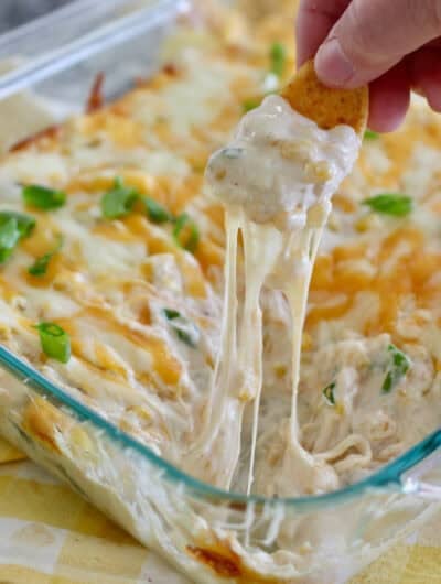 Hot corn dip out of the oven with frito scoop