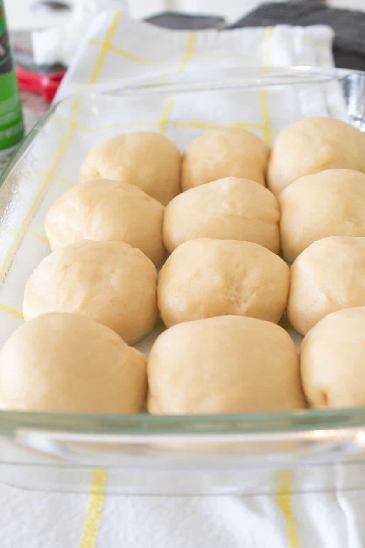 rolled hawaiian rolls in a clear casserole dish