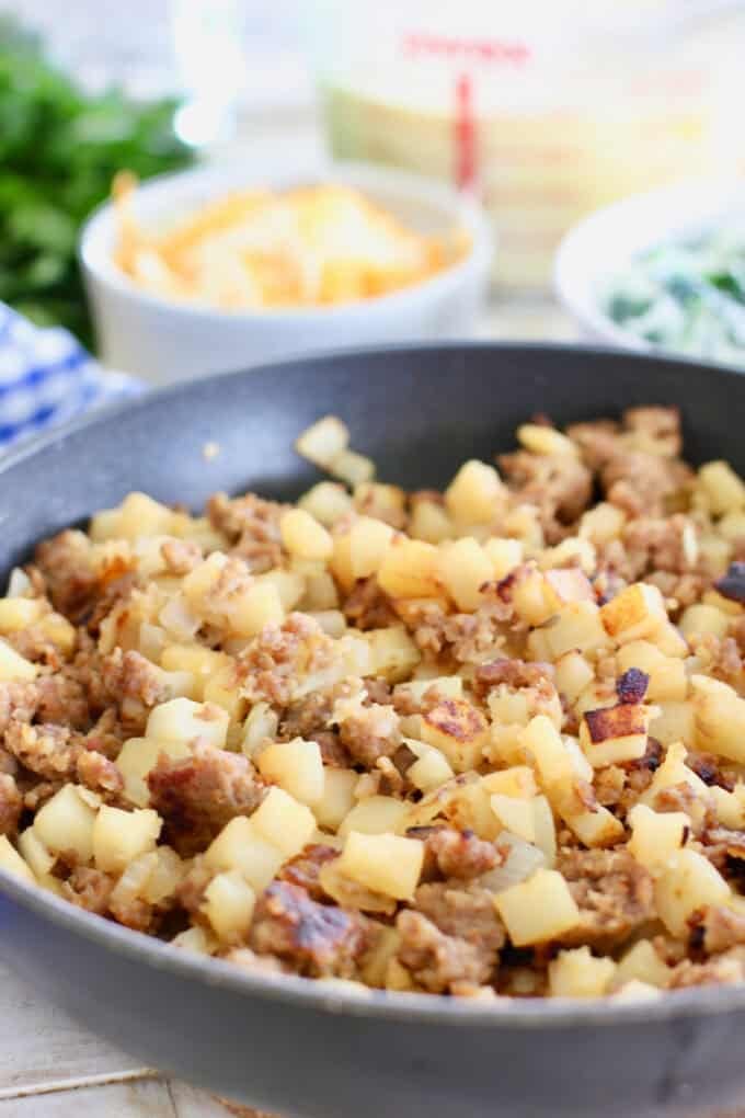 browned sausage and potatoes in a skillet