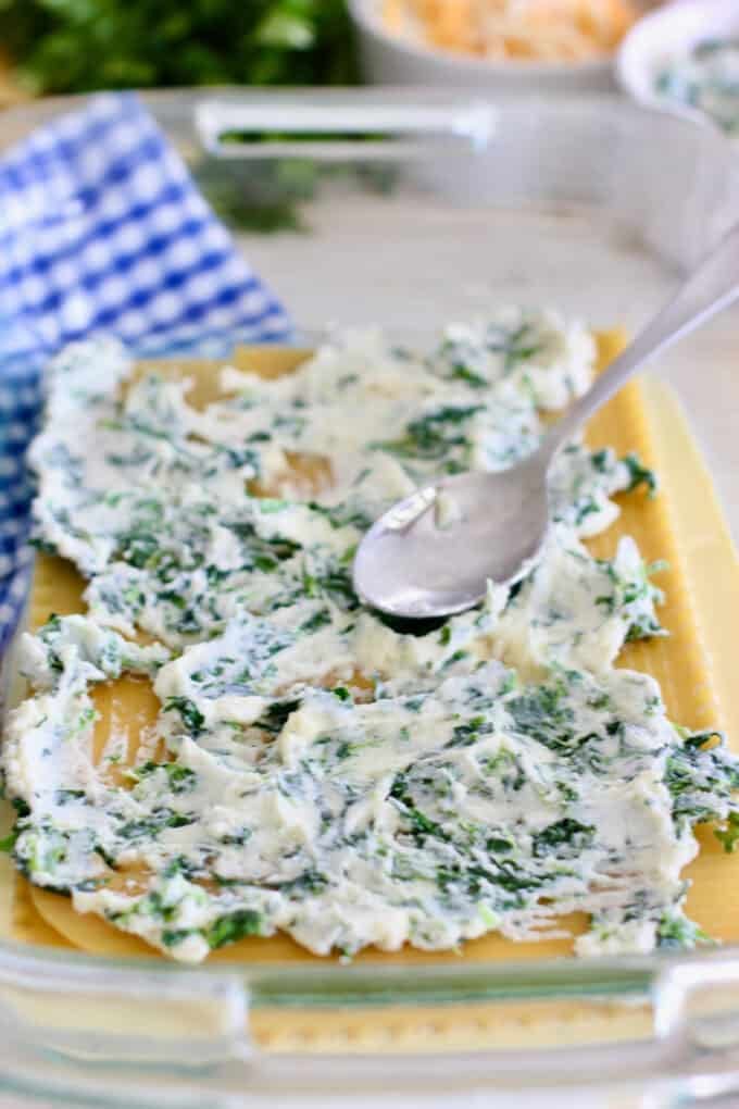 ricotta and spinach being spread on breakfast lasagna