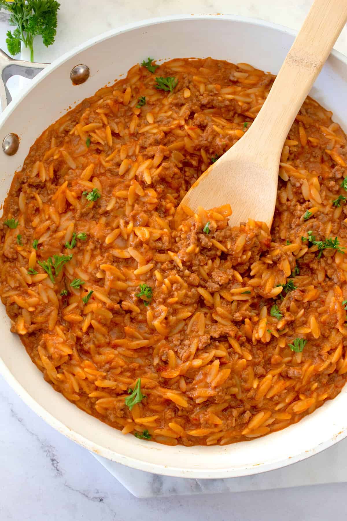 overhead view of beef orzo in a pan