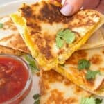 hand grabbing a slice of quesadilla