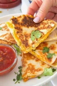 hand grabbing a slice of quesadilla