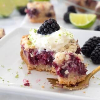 closeup of blackberry pie bar on a white plate