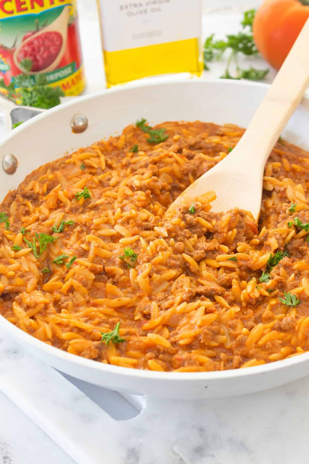 side view of beefy tomato orzo in a pan