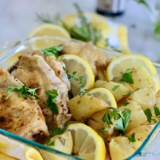 Lemon baked chicken thighs with potatoes in a casserole dish