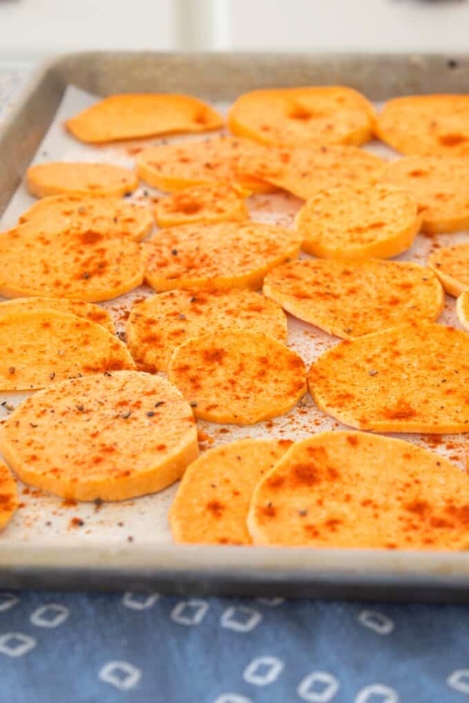 seasoned sweet potato chips on parchment paper