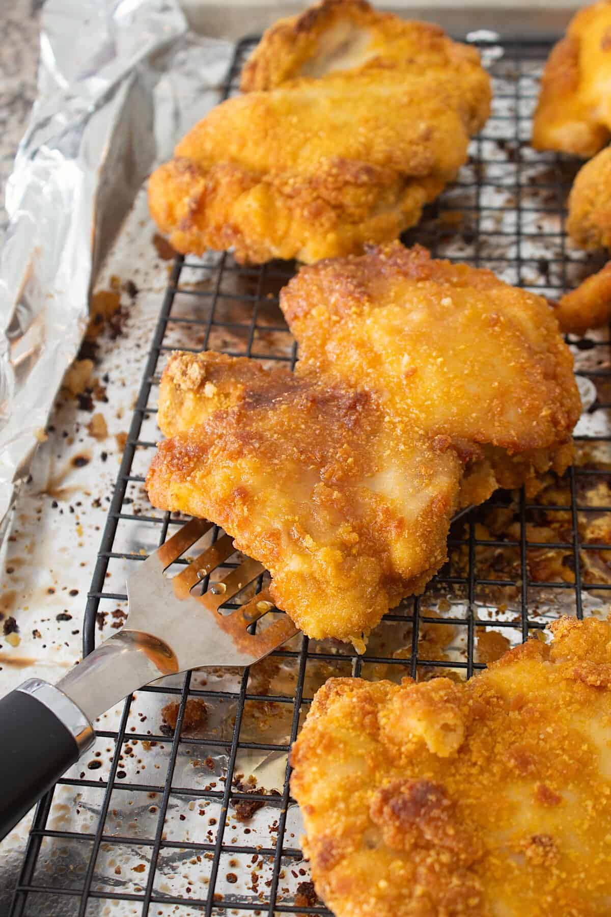 crispy crunchy chicken on a sheet pan with a rack