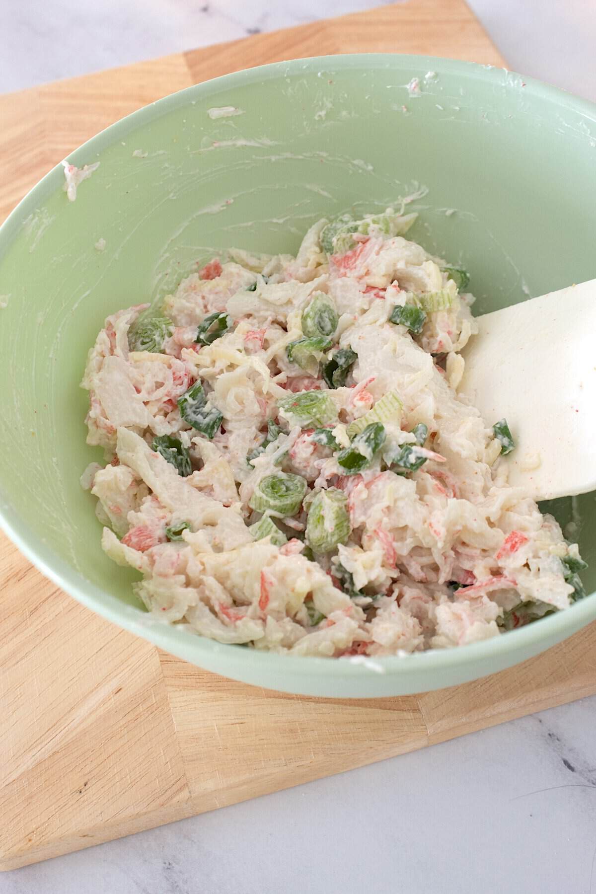 crab rangoon mixture in a light green bowl